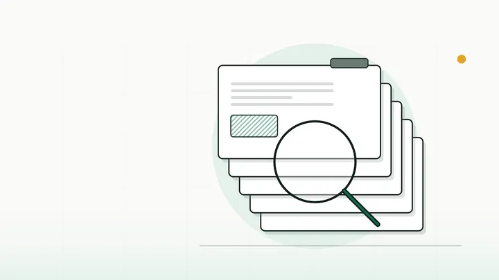 A magnifying glass over a stack of blank claim cards with coloured tabs (illustration)